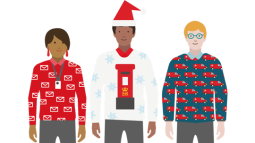 Three people in Royal Mail Christmas jumpers