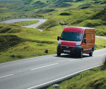 Royal Mail van driving in the countryside